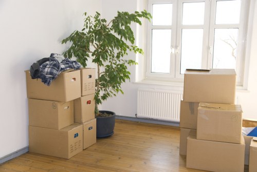 Packed office furniture and boxes ready for a business move in West Hampstead
